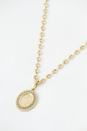 Gold-toned art gold jewelry necklace with round religious pendant surrounded by sparkling stones by rinaldo borges