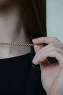A delicate gold chain necklace with a fine interlocking link design perfect for custom gold jewelry lovers