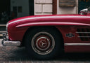 Glossy red Mercedes-Benz 300 SL with chrome accents evoking graff diamonds luxury