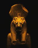 Golden stone statue of an ancient Egyptian pharaoh wearing a lion-headed crown showcasing fine 18k gold jewelry craftsmanship.