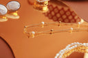 Gold chain necklace with delicate pearl accents highlights fine jewelry care for 18k gold jewelry shine and brilliance