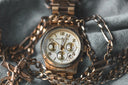 Gold-tone michael kors chronograph watch with white dial and three subdials resting on denim fabric for fine jewelry care