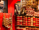 Stacks of vibrant red velvet bangles with intricate gold detailing showcasing fine jewelry and art gold craftsmanship.