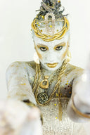 Woman with elaborate gold and silver body paint and jewelry