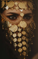 A woman is wearing golden jewelry.
