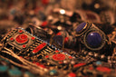 A gold-toned bracelet with red and blue stones featured in cleopatras gold at everett jewelry store article.