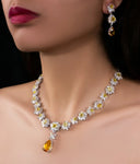 Elegant jewelry set adorns a woman's neck.
