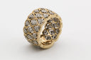 A luxurious gold jewelry ring with a bold quilted design and sparkling diamonds in a geometric pattern.