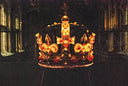 Gold crown adorned with red and yellow gemstones featuring intricate filigree and a central cross in art gold jewelry style