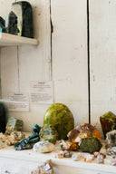 A polished oval emerald gemstone with vibrant green hue and natural inclusions featured in fine gold jewelry.