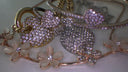 A sparkling gold heart-shaped charm with clear rhinestones on a delicate 18k gold chain for fine jewelry gifts.