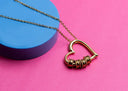 Gold heart pendant necklace with rings