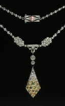 Elegant diamond and gemstone necklace with cascading teardrop pendant in platinum, inspired by royal jewels and historical crowns.