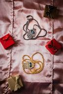 Silver and gold hamsa hand pendants with blue eyes on twisted chain and braided rope in ancient jewelry context