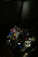 A dazzling multi-colored gemstone ring with vibrant stones in a dark metal band featured in fine jewelry history