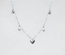 a silver heart necklace on a white background