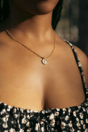 A close up of a woman wearing a necklace