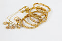 A collection of 18k gold jewelry with twisted designs and diamonds including luxury gold rings bangles and necklace.