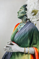 Woman with colorful draped fabric and ornate jewelry