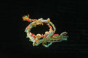Handmade art gold jewelry: colorful braided bracelet with charms