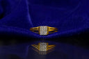 Gold ring with diamonds on blue fabric