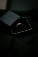 a black box with a gold ring inside of it