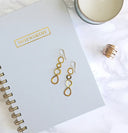 Gold-toned drop earrings with interconnected oval and teardrop links crafted from 18k gold fine jewelry in everett ma