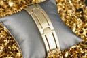 Mens gold bracelet with broad flat links and curved design