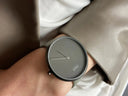 A minimalist gray Piaget Mikimoto watch with textured dial and slim metallic hands featured by Everett jewelry store.
