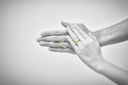 Two hands with 18k gold wedding bands from fine jewelry collection