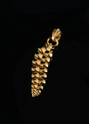 a gold pendant on a black background