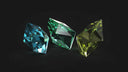 Three faceted rarest gemstones in blue green and yellow green with polished surfaces for 18k gold jewelry and engagement rings