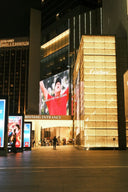 The illuminated cartier storefront with a golden lit facade showcases art gold design in a luxury gold jewelry setting