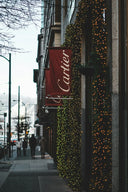 A red cartier banner highlighting fine jewelry trends in 18k gold and gold jewelry for this season