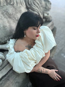 Elegant cream off-shoulder blouse with ruffles for 18k gold jewelry