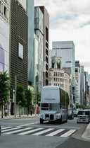A sleek white vintage double-decker bus featuring the ferragamo logo amid art gold jewelry inspiration in mikimoto influence