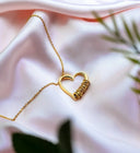 A delicate gold heart-shaped pendant necklace featuring a textured coiled design in fine gold jewelry trends.