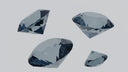 Four faceted gray gemstones with reflective surfaces featured in cultural jewelry traditions for engagement rings at everett jewelry store