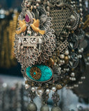Silver filigree peacock brooch with turquoise, gold birds, and pearls complements engagement rings at Everett jewelry store.