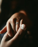 A delicate rose gold engagement ring with square-cut diamond and pavé diamonds crafted in 18k gold fine jewelry.
