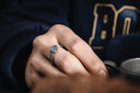 a close up of a person wearing a ring