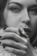 Ornate engagement ring with filigree and cursed gem secret