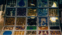 A vibrant display of faceted gemstones in various colors and cuts for art gold and 18k gold jewelry designs