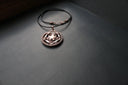 Ethical copper-toned art gold jewelry pendant in 18k gold, on black leather cord