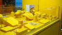 Gold necklace displayed on a yellow mannequin neck stand showcasing 18k gold fine jewelry and gold jewelry styles
