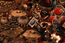 An ornate silver bracelet with intricate filigree and red turquoise stones in the context of art gold jewelry evolution.