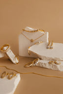 Gold-toned diamond-studded twisted band engagement ring highlighting ethical jewelry and 18k gold jewelry practices