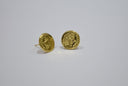 Gold-colored round stud earrings with intricate embossed designs showcasing historical gold jewelry craftsmanship