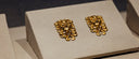 Golden 18k gold lion-head earrings with intricate scrollwork showcasing fine gold jewelry elegance and craftsmanship.