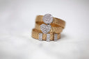 Gold-toned 18k woven band engagement ring with round and heart-shaped diamond cluster in fine jewelry trends.